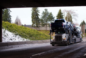 a car shipping truck moving vehicles in the winter when auto transport prices are lower