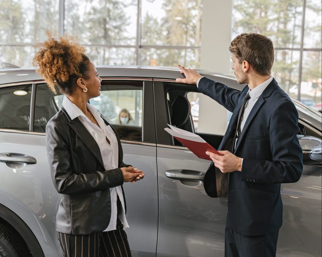 A woman and salesman talking about car specifications